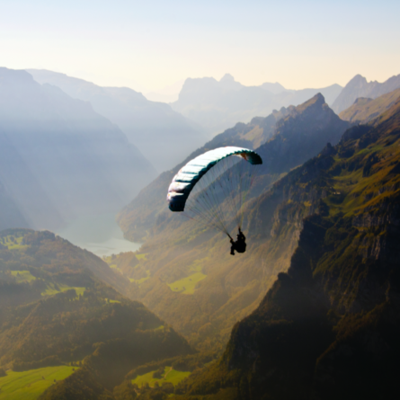 Paraglider over mountain range