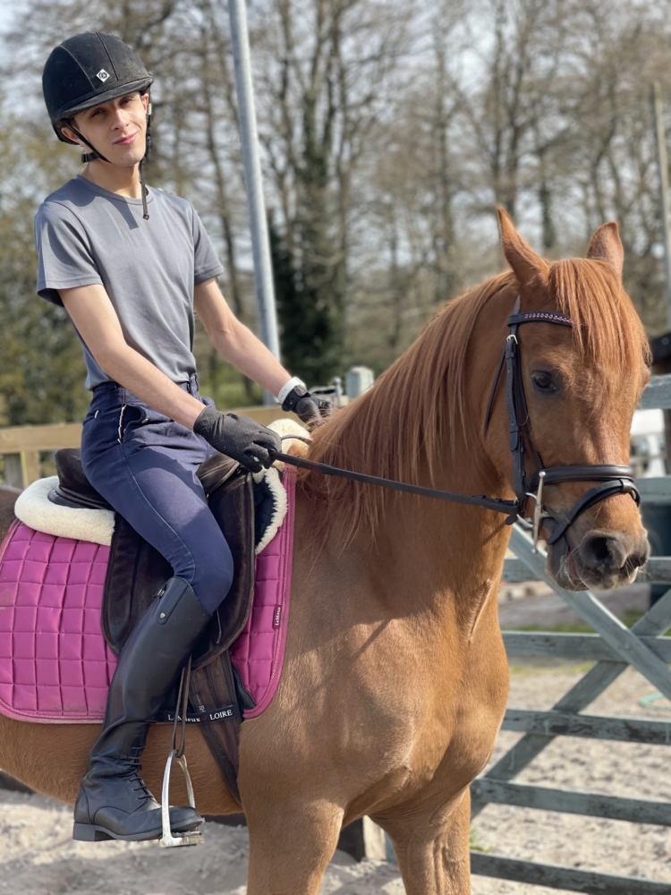 Ryan riding a brown horse