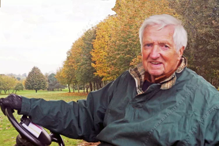 Colin Andrews in a golf buggy