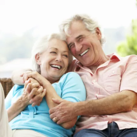 Older couple hugging and laughing together