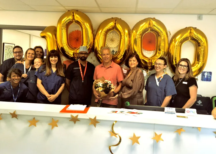 Nigel Turner, patient, with staff at Optegra Brighton celebrating being the 10,000th patient